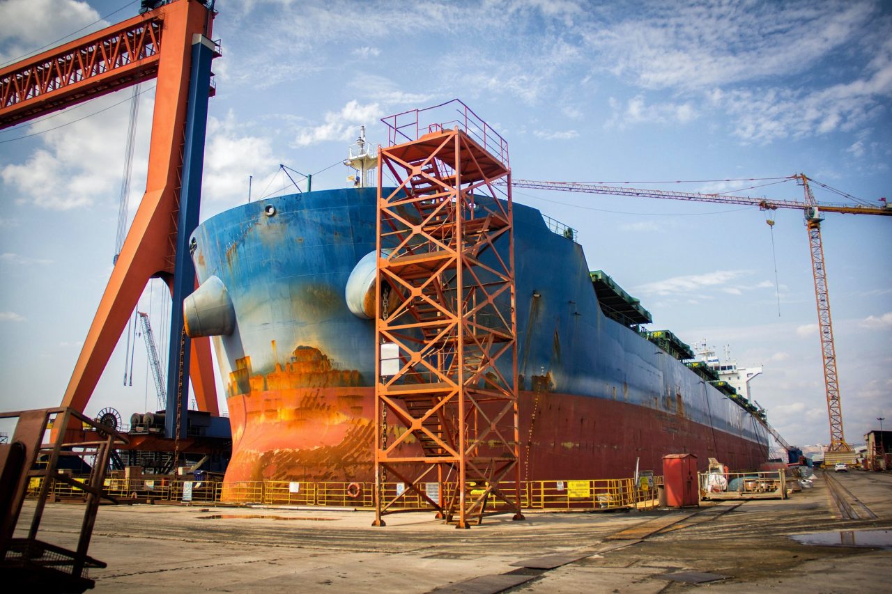 A Large Tanker Cargo Ship Is Being Renovated And Painted In Shipyard Dry Dock.jpg