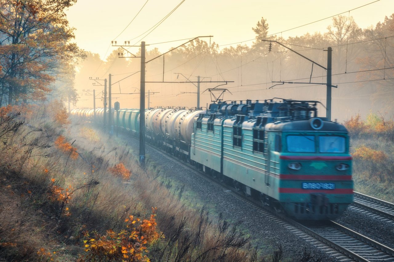 Moving Freight Train In Beautiful Forest In Fog At Sunrise.jpg